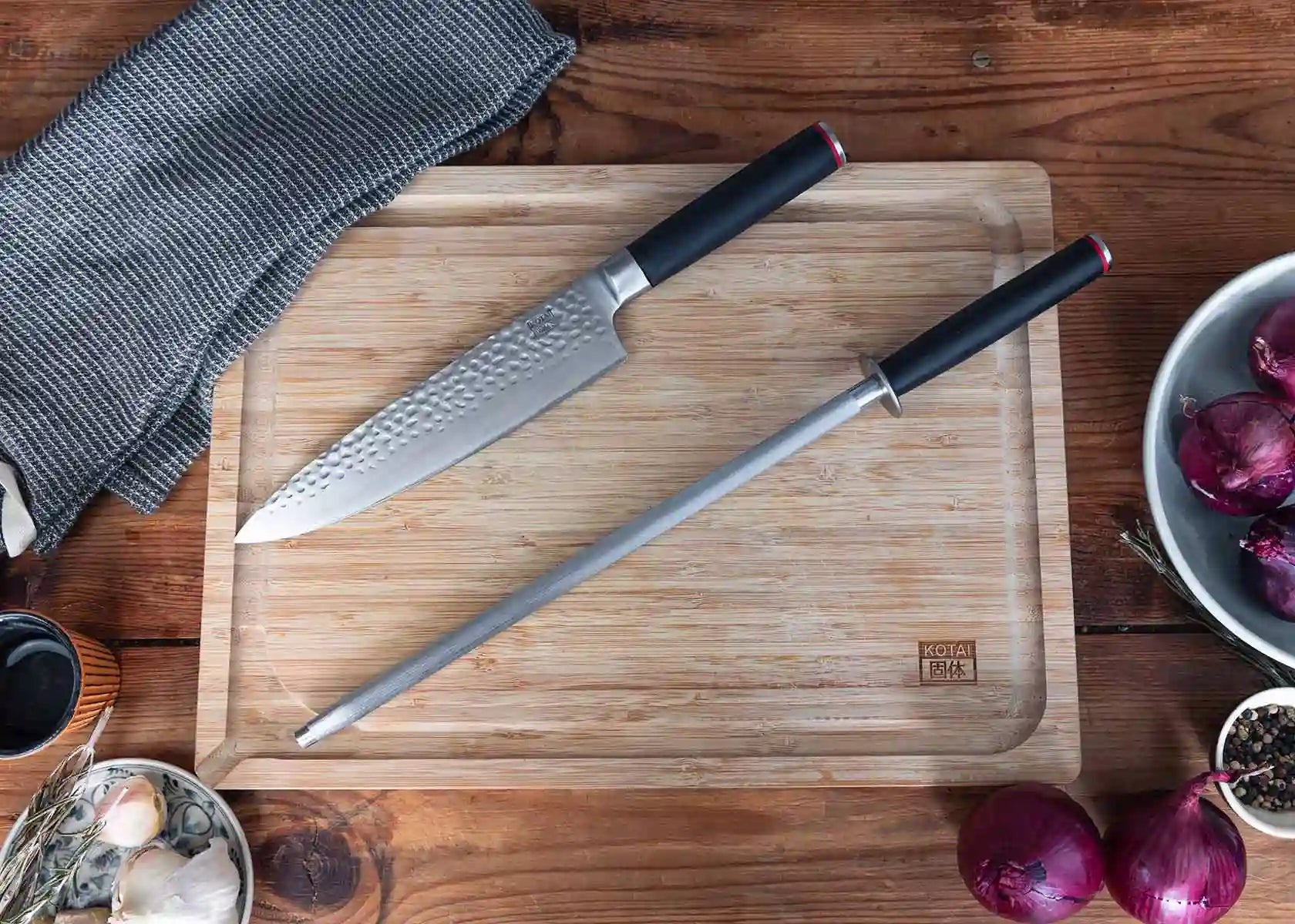kotai koksmes gyuto en aanzetstaal op houten snijplank